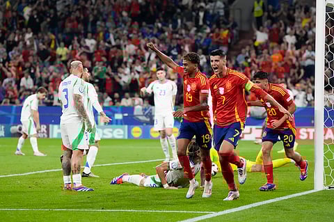 Spain's Alvaro Morata (7), Lamine Yamal (19) Pedri (20) celebrate after an own goal by Italy's Riccardo Calafiori during a Group B match between Spain and Italy at the Euro 2024 soccer tournament on June 20, 2024. 