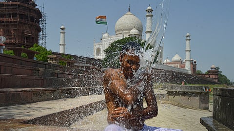 A man cools himself to get relief from the scorching heat on a hot summer day, near Taj Mahal in Agra, Tuesday, June 18, 2024.