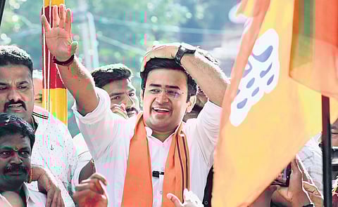 Bangalore South BJP winner Tejasvi Surya celebrates with his supporters after he was declared the winner, in Bengaluru on Tuesday