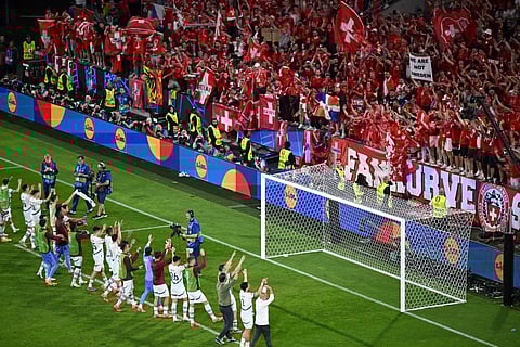 Swiss players greet their supporters at the end of the UEFA Euro 2024 Group A football match between Scotland and Switzerland at the Cologne Stadium in Cologne on June 19, 2024. 