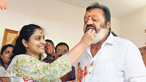 A jubilant Suresh Gopi, who won from the Thrissur Lok Sabha constituency, savours sweets offered by his wife Radhika at their house at Sasthamangalam in Thiruvananthapuram on Tuesday
