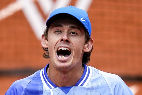 Australia's Alex de Minaur celebrates after winning his fourth round match of the French Open tennis tournament against Russia's Daniil Medvedev at the Roland Garros stadium in Paris, Monday, June 3, 2024.