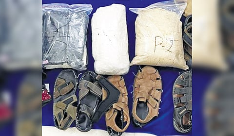 The woman from Ghana had sealed cocaine packets to the bottom of five pairs of shoes