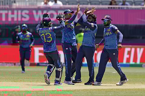 Sri Lanka's captain Wanindu Hasaranga, second right, celebrates with teammates after the dismissal of South Africa's Quinton de Kock during the ICC Men's T20 World Cup cricket match on June 3, 2024.