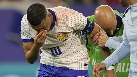 Kylian Mbappe of France holds his nose after suffering an injury during a Group D match between Austria and France at the Euro 2024 soccer tournament in Duesseldorf, Germany, Monday, June 17, 2024.
