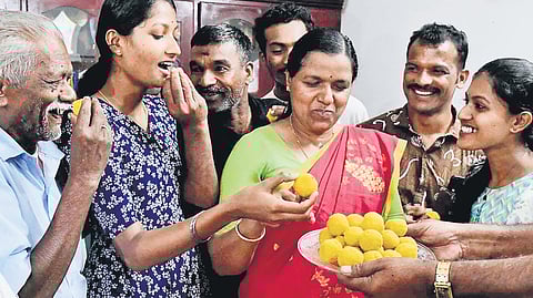 Father Raman, wife Santha and daughters Bhavana and Midhuna celebrating at the house of minister-designate O R Kelu in Wayanad 