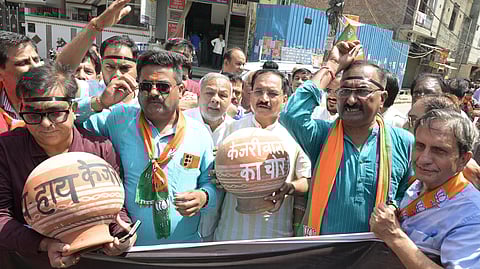 
Delhi BJP President Virendra Sachdeva with others demonstrate against Kejriwal Government for Water Crisis at Geeta Colony in New Delhi on Monday.