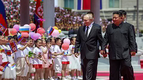 Russian President Vladimir Putin, left, and North Korea's leader Kim Jong Un, foreground right, attend the official welcome ceremony in the Kim Il Sung Square in Pyongyang.
