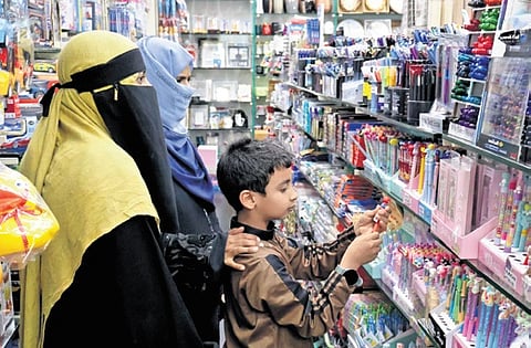 A kid buys stationery as schools will reopen on June 12