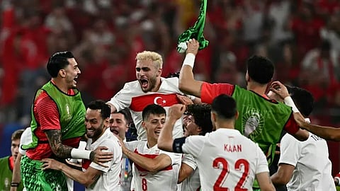 Turkey's players celebrate qualifying for the knock-out stages at the end of the UEFA Euro 2024 Group F football match between the Czech Republic and Turkey at the Volksparkstadion in Hamburg on June 26, 2024. 