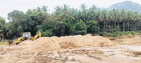 An earthmover used in illegal sand mining seized at Ponnampatti 