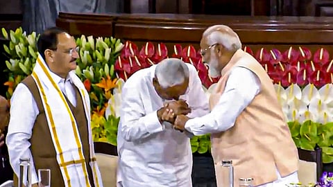 Senior BJP leader Narendra Modi with Bihar CM and JD(U) leader Nitish Kumar during the NDA parliamentary party meeting at Samvidhan Sadan. 