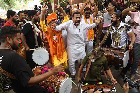 BJP supporters celebrate the party's lead in the Lok Sabha elections at party headquarters as counting of votes underway, in New Delhi 