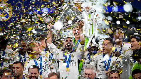 Real Madrid's players celebrate with the trophy after winning the Champions League final soccer match between Borussia Dortmund and Real Madrid at Wembley stadium in London, Saturday, June 1, 2024. 