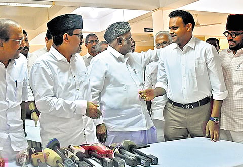 IUML national president K M Kader Mohideen congratulating V K Haris Beeran in Thiruvananthapuram on Monday. Party state president Sadik Ali Shihab Thangal, MLA P K Kunhalikutty and MP Abdusamad Samadani are also seen 