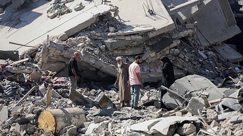 Palestinians sift through the rubble of their home in the wake of an Israeli air and ground offensive in Jebaliya, northern Gaza Strip after Israeli forces withdrew from the area