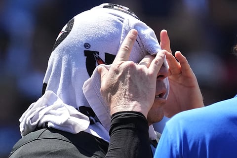 Home plat umpire Carlos Torres cools off during the ninth inning of a baseball game between the St. Louis Cardinals and the Chicago cubs in Chicago, Sunday, June 16, 2024.
