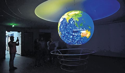 A visitor clicking a photo of Science on Sphere (SoS), a product by NOAA, USA