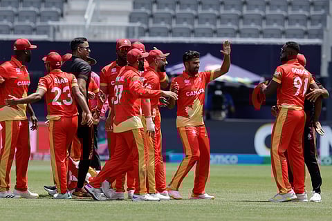 Canada players celebrate their victory by 12 runs over Ireland at an ICC Men's T20 World Cup cricket match on June 7, 2024.