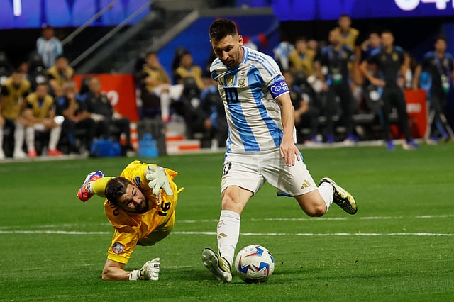 Argentina's Lionel Messi lines up a shot, as he gets past Canada's goalkeeper during a Copa América match