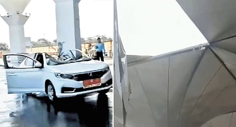 Damaged car and the caved in portion of the fabric canopy at the Jabalpur Airport in MP 