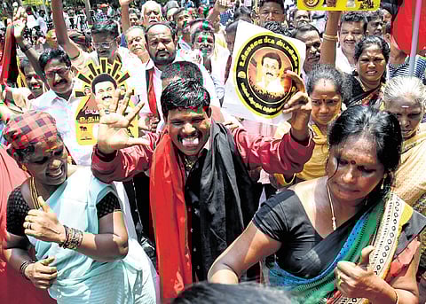 DMK workers celebrate at Anna Arivalayam in Chennai on Tuesday