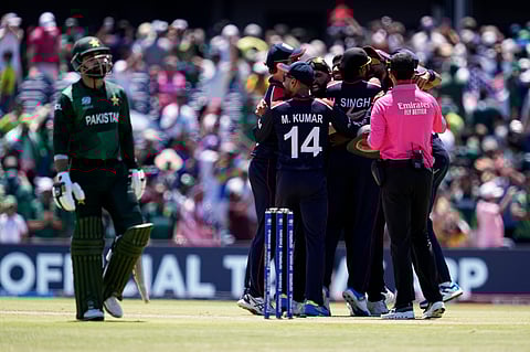 Pakistan's Shadab Khan, left, walks off the field as players of United States celebrate after their win in the ICC Men's T20 World Cup cricket match (Photo | AP)