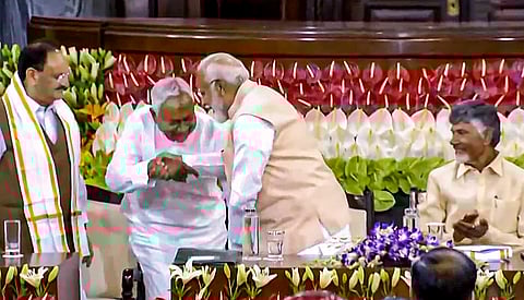 Senior BJP leader Narendra Modi with Bihar CM and JD(U) leader Nitish Kumar during the NDA parliamentary party meeting at Samvidhan Sadan, in New Delhi.