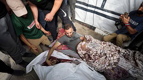 Palestinians mourn their relatives killed in an Israeli bombardment on a residential building owned by the Akel family in Bureij refugee camp, at al-Aqsa Martyrs hospital in Deir al-Balah, central Gaza Strip.