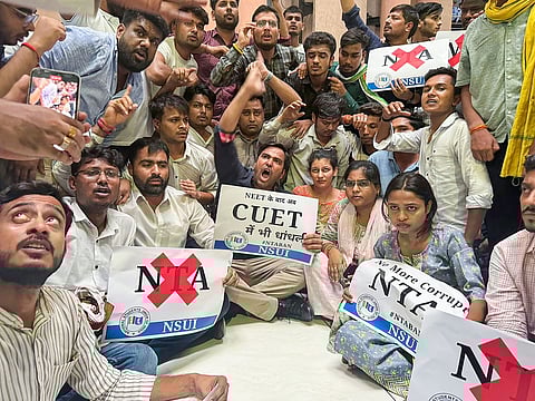 Members of NSUI, Congress's students wing, raise slogans during their protest over the alleged rigging of the NEET UG exams. 