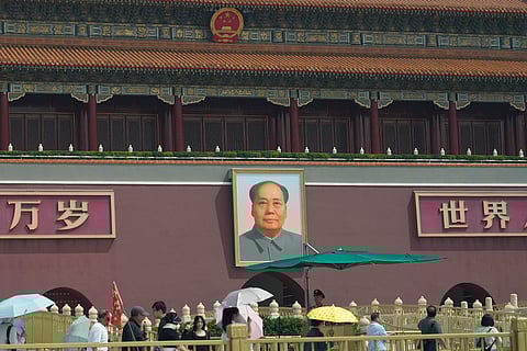 Police officers watch over Tiananmen Gate in Beijing, Tuesday, June 4, 2024. 