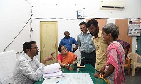 Collector G Lakshmipathy receiving petitions from an old woman at Ettayapuram taluk.