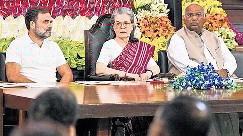 Congress president Mallikarjun Kharge with party leaders Sonia Gandhi and Rahul Gandhi at the Central Hall of Parliament in New Delhi on Saturday.