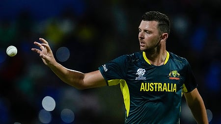 Australia's Josh Hazlewood reaches for a ball while bowling against Namibia during an ICC Men's T20 World Cup cricket match.