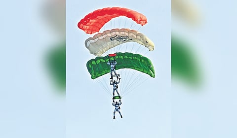  IAF officers perform a paragliding stunt 