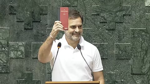 Congress MP Rahul Gandhi shows a copy of the Constitution of India while taking oath as a Member of the 18th Lok Sabha during its second day, at the Parliament, in New Delhi.