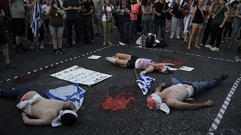 Demonstrators are painted red, symbolizing blood against Israeli Prime Minister Benjamin Netanyahu's government and demanding elections, in Tel Aviv, Israel, Saturday, June 22, 2024.