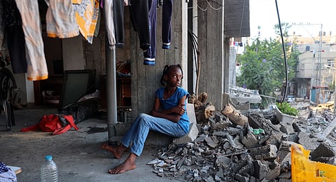 A displaced Palestinian girl sits in a damaged building used as a temporary shelter in al-Bureij refugee camp in the central Gaza Strip on June 12, 2024, amid the ongoing conflict between Israel and the Hamas militant group.