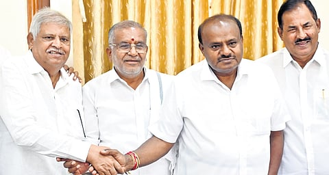 JDS state president HD Kumaraswamy congratulates party MLC candidate Javarayi Gowda at Vidhana Soudha in Bengaluru on Monday