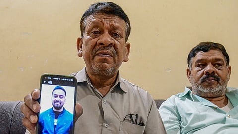 Mubarak Hussain, father of Md Ali Hussain, shows a photograph of his son on a smartphone after the latter died in the recent fire incident in Kuwait, in Ranchi, Friday, June 14, 2024.