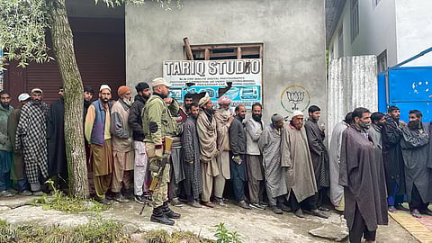 People stand in queues to cast their votes at a polling station during the fourth phase of Lok Sabha elections at Fakeer Gujri on the outskirts of Srinagar, Monday, May 13, 2024. 
