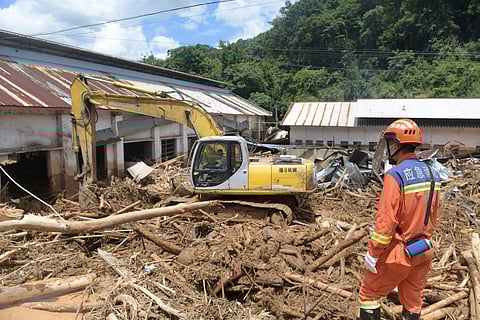 In this photo released by Xinhua News Agency, rescuers clear debris in a flood-affected area in Sishui Township of Pingyuan County, Meizhou City, southern China's Guangdong Province, June 20, 2024.