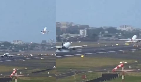 An Indigo flight lands as another Air India flight takes off. 