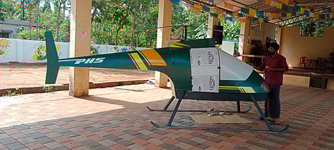Prabhan with the helicopter he made