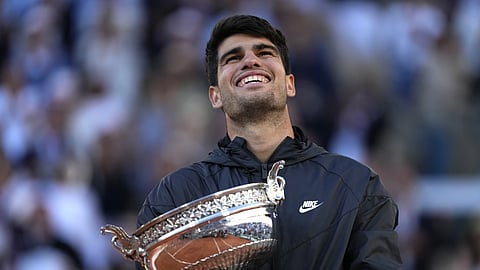 Carlos Alcaraz celebrates with the trophy after he won the men's final match of the French Open tennis tournament against Germany's Alexander Zverev at the Roland Garros stadium in Paris, Sunday, June 9, 2024.
