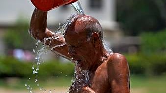 A man cools off himself during a hot summer day at a park in Karachi, Pakistan.