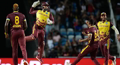West Indies' Nicholas Pooran, second left, celebrates after taking a catch to dismiss New Zealand's captain Kane Williamsond uring the men's T20 World Cup cricket match between the West Indies and New Zealand at the Brian Lara Cricket Academy, Tarouba, Trinidad and Tobago, Wednesday, June 12, 2024.