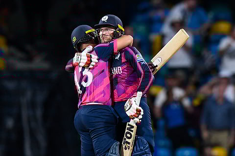 Scotland's Chris Greaves (L) and Scotland's captain Richie Berrington celebrate winning the ICC men's Twenty20 World Cup 2024 match between Namibia and Scotland on June 6, 2024.