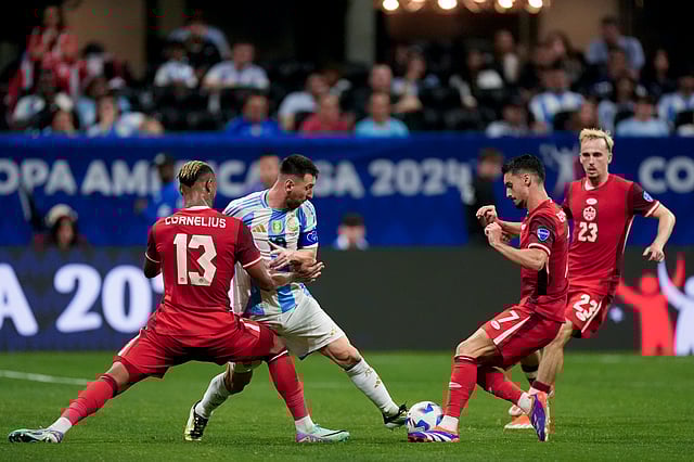Lionel Messi, dribbling past Canada's defence during a Copa America  match