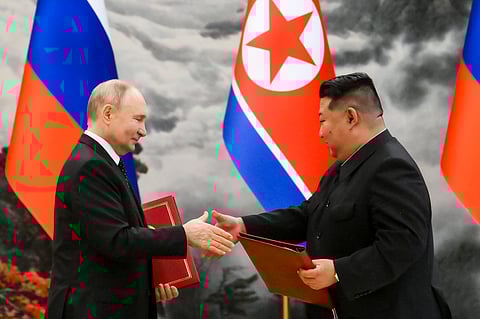 Russian President Vladimir Putin, left, and North Korea's leader Kim Jong Un exchange documents during a signing ceremony of the new partnership in Pyongyang (Photo | AP)